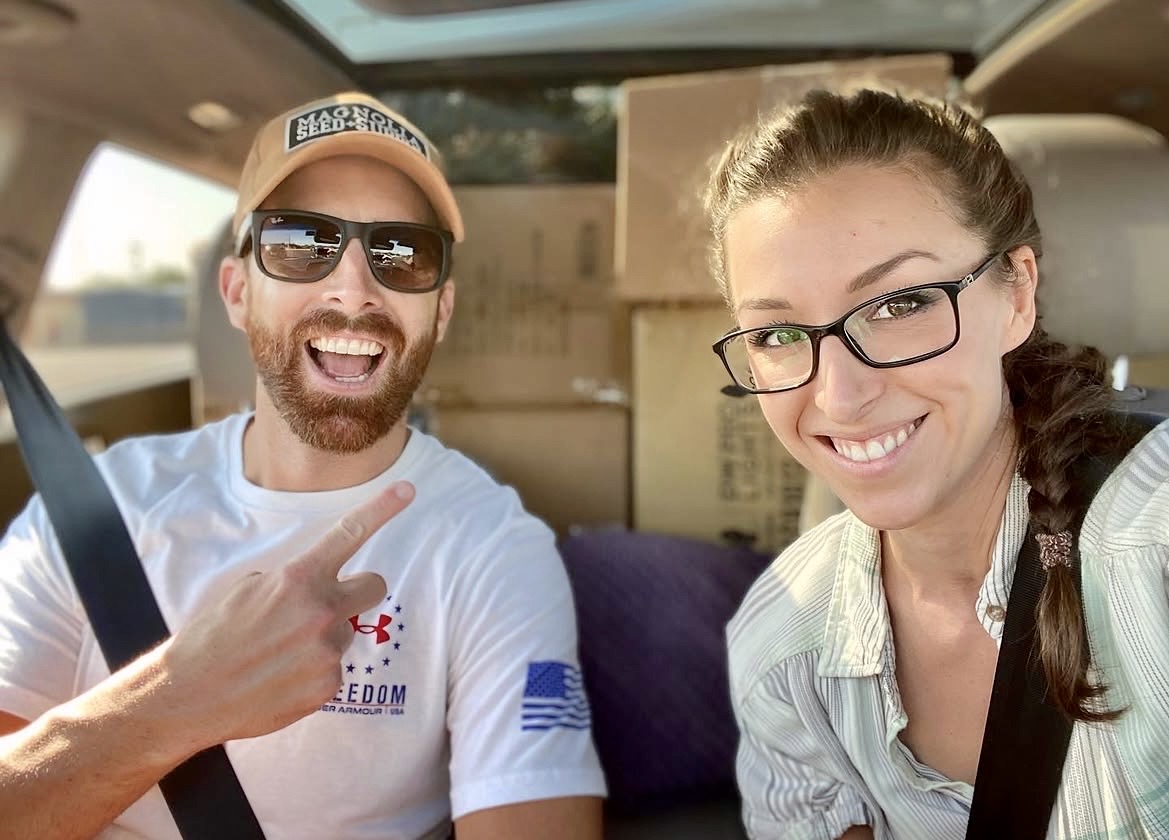 Pat and Amanda Murphey in the truck loaded with Christmas light boxes
